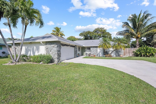 single story home featuring a garage and a front lawn