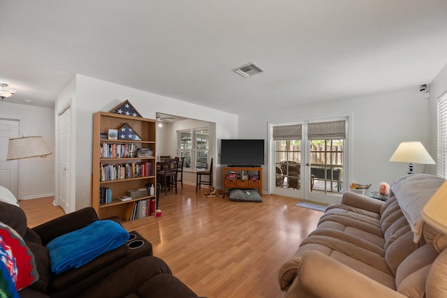 living room featuring light hardwood / wood-style flooring and french doors