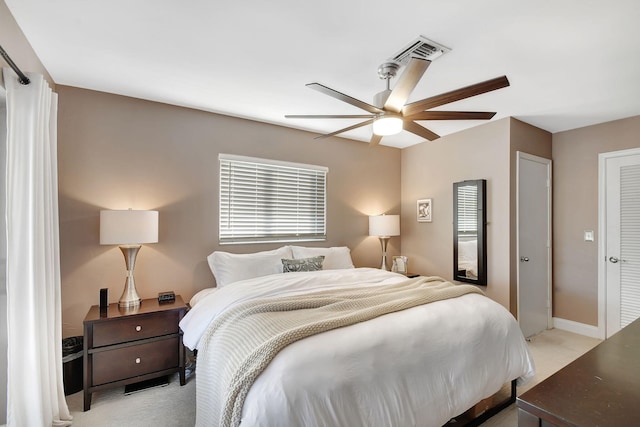 bedroom with light carpet and ceiling fan