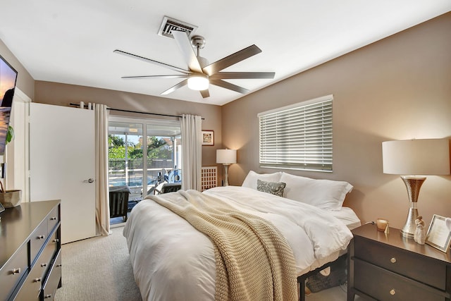 carpeted bedroom with ceiling fan and access to outside