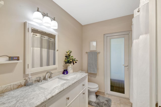 bathroom featuring vanity, tile patterned flooring, and toilet