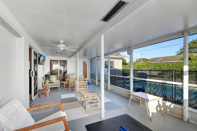 sunroom / solarium with plenty of natural light and ceiling fan