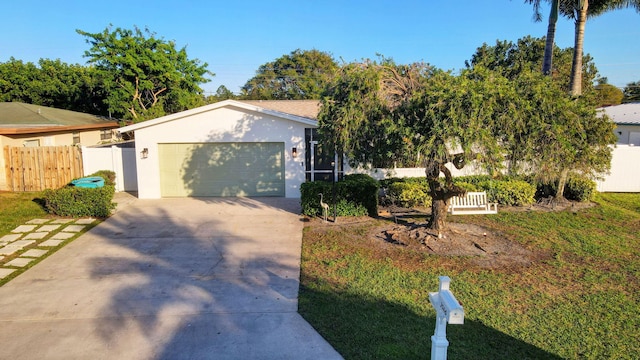 view of front of house with a garage and a front lawn