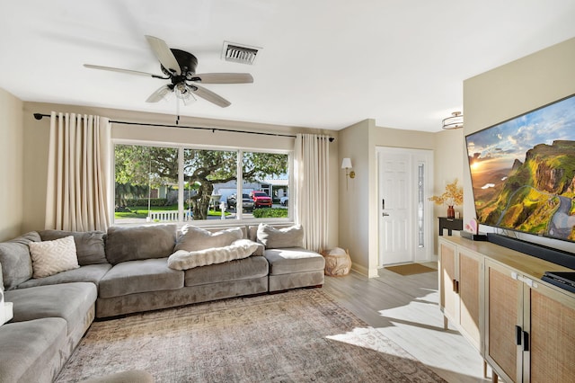 living room with light hardwood / wood-style floors and ceiling fan