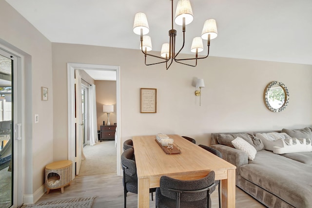 dining room featuring light hardwood / wood-style floors and a chandelier