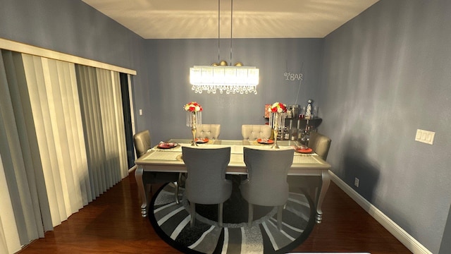 dining room with dark hardwood / wood-style flooring