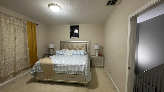 carpeted bedroom with a textured ceiling