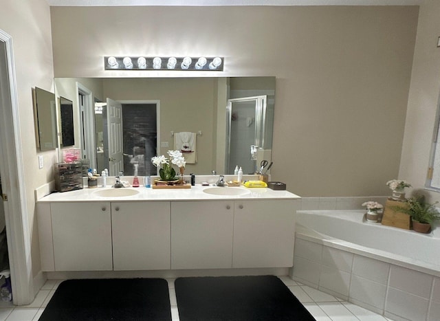 bathroom with tile patterned flooring, shower with separate bathtub, and vanity