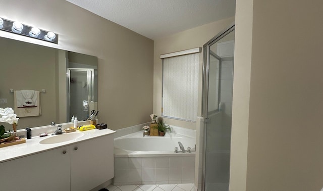 bathroom featuring vanity, separate shower and tub, tile patterned flooring, and a textured ceiling