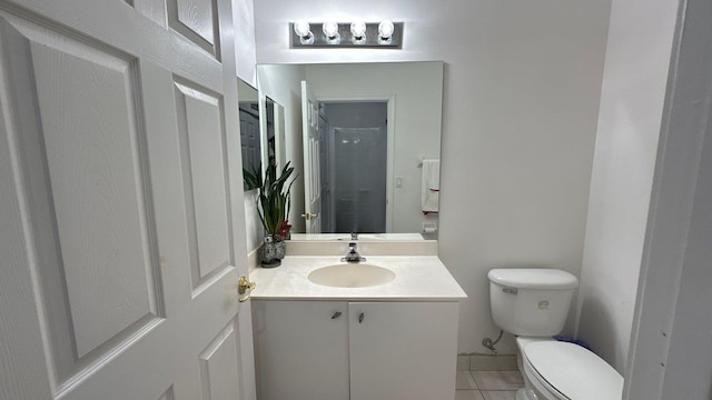 bathroom with tile patterned flooring, vanity, and toilet