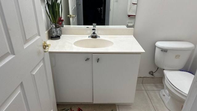 bathroom with tile patterned flooring, vanity, and toilet