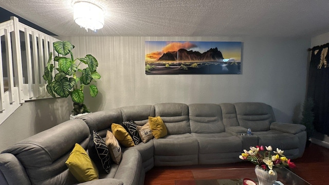 living room with wood-type flooring and a textured ceiling