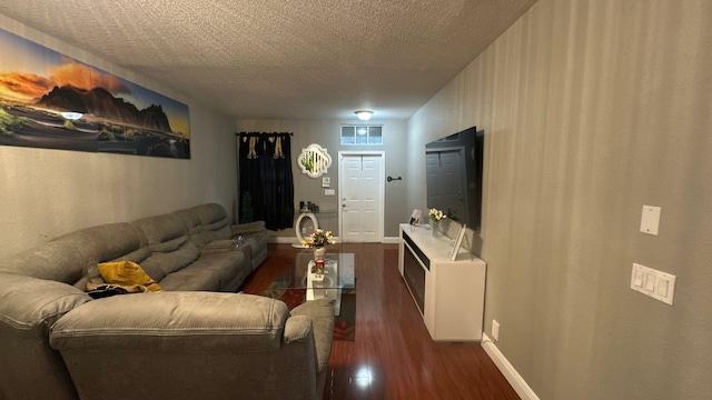 living room with dark wood-type flooring and a textured ceiling