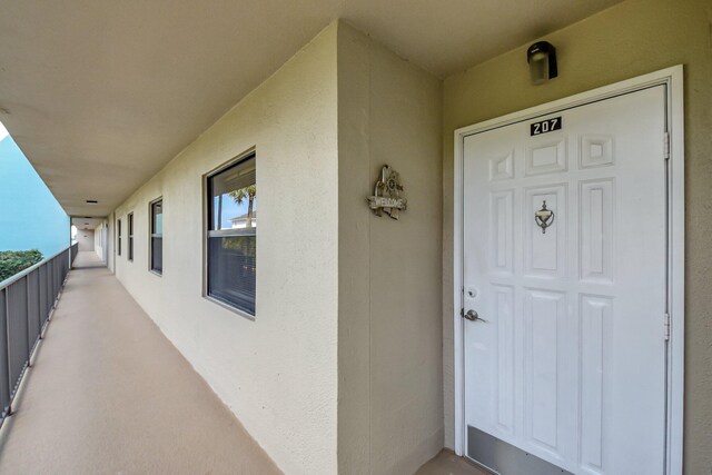 property entrance with stucco siding