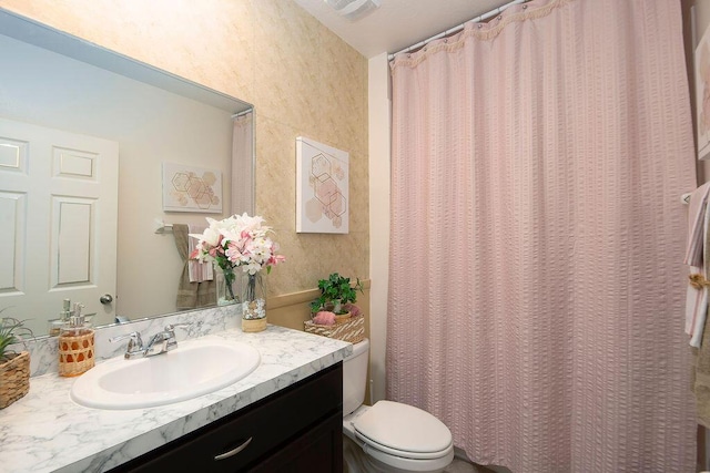 bathroom featuring vanity and toilet