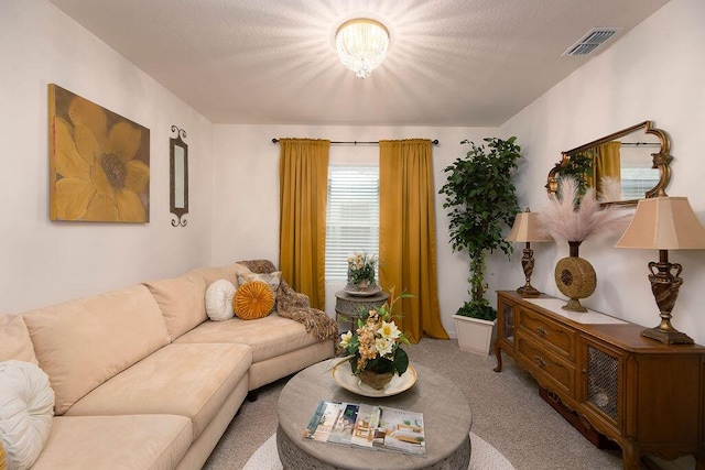 living room featuring light colored carpet and a notable chandelier