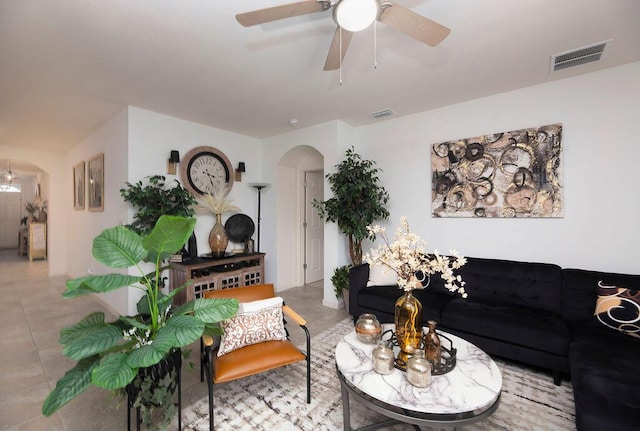 tiled living room with ceiling fan