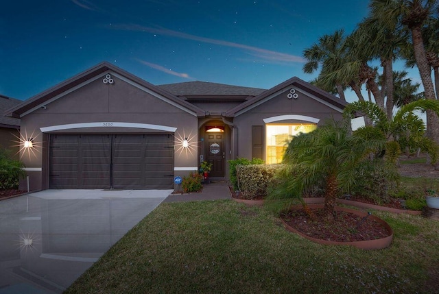 ranch-style home featuring a yard and a garage