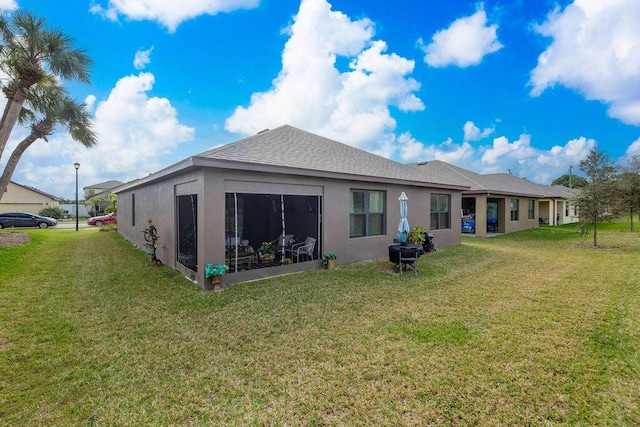 rear view of property with a yard