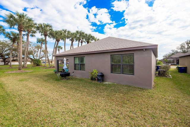 rear view of house with a yard