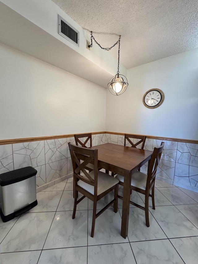 dining area featuring a textured ceiling