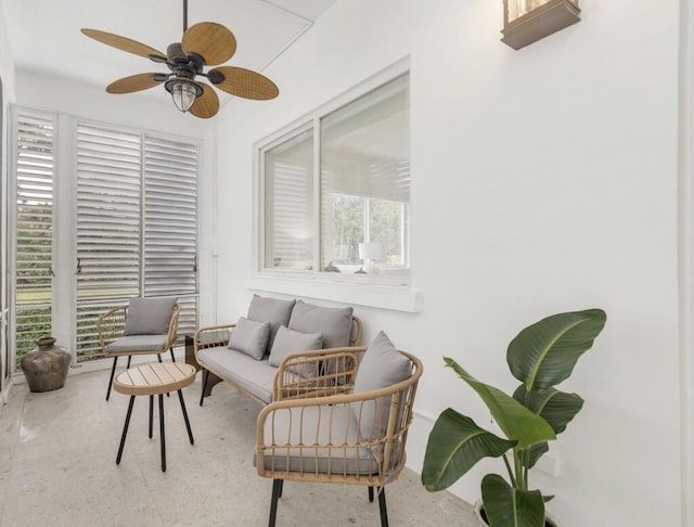 sitting room with a wealth of natural light and ceiling fan