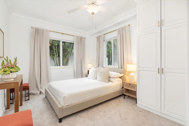 carpeted bedroom with crown molding and ceiling fan