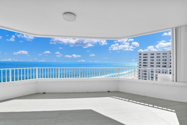 balcony with a beach view and a water view