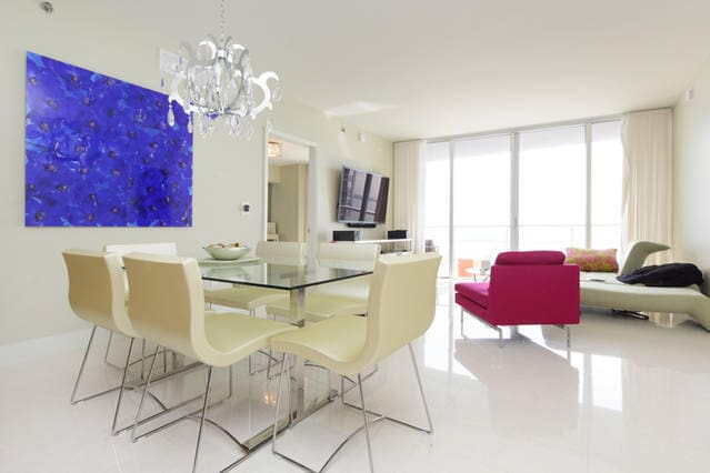 dining space with a wall of windows and a chandelier