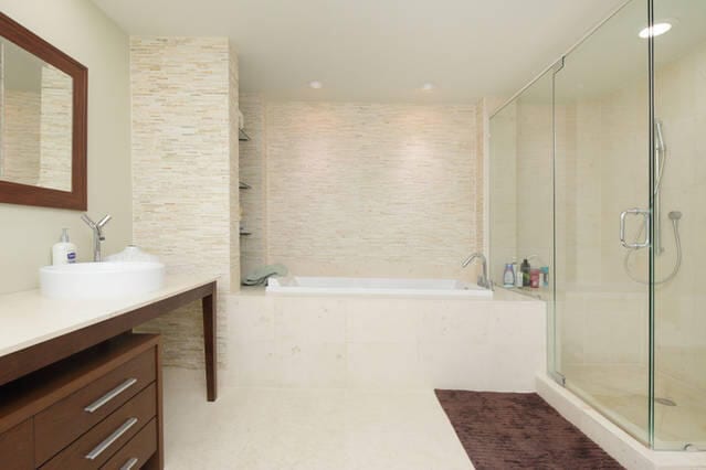 bathroom featuring plus walk in shower and vanity