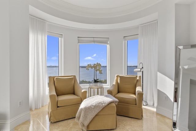 living area with crown molding and a water view