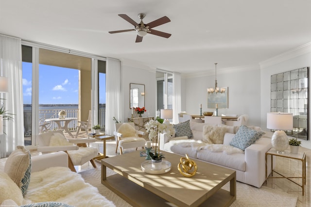 living room with floor to ceiling windows, ceiling fan with notable chandelier, and crown molding