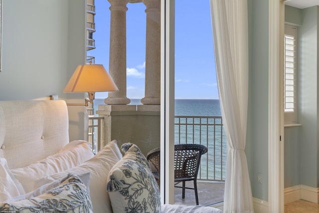 living area featuring plenty of natural light and a water view