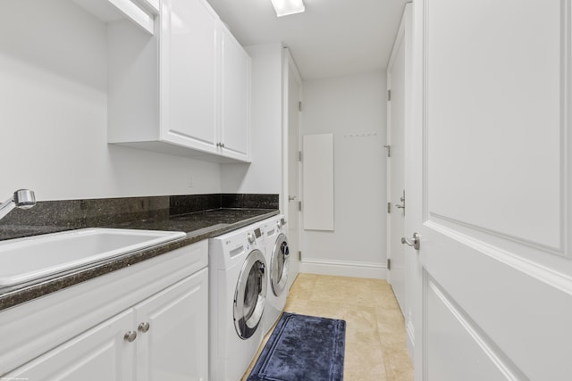 laundry area with separate washer and dryer, sink, light tile patterned floors, and cabinets