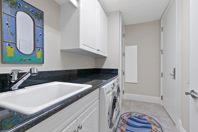 laundry area featuring sink, light tile patterned floors, and independent washer and dryer