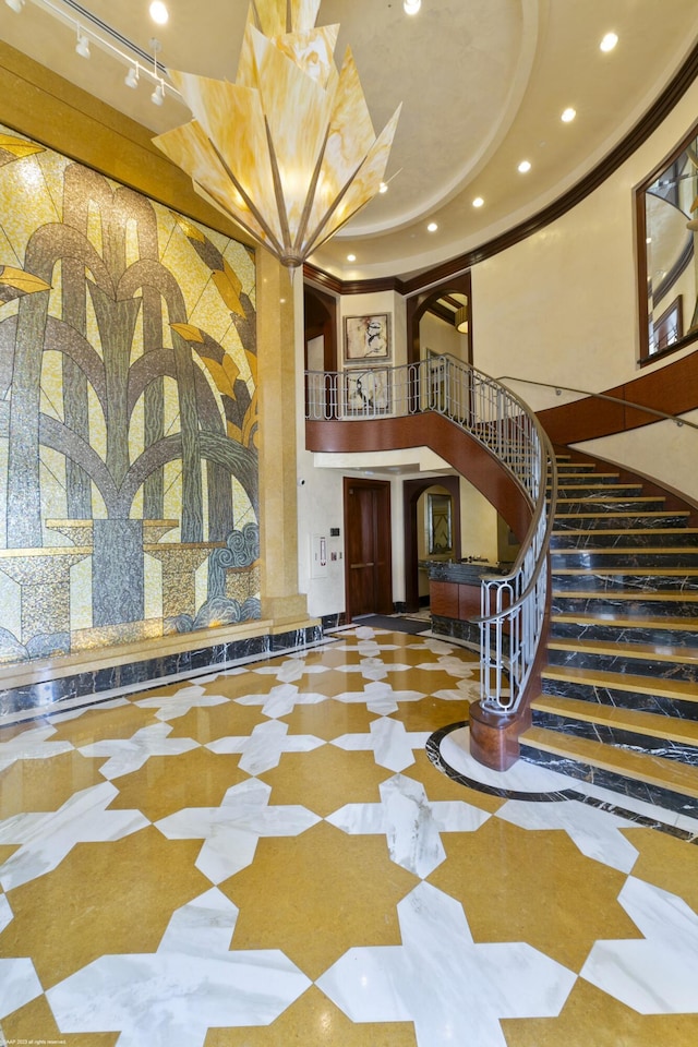 interior space featuring a raised ceiling and a high ceiling