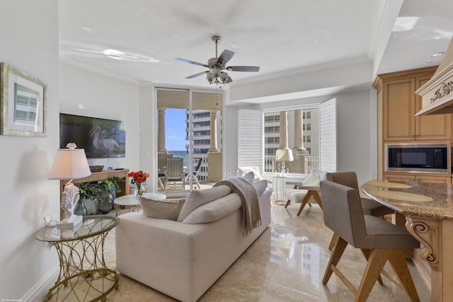 living room with ornamental molding and ceiling fan