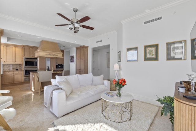 living room featuring ceiling fan and ornamental molding