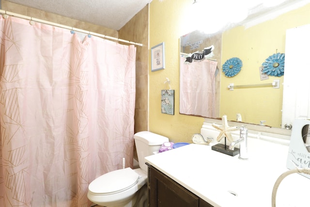 bathroom with vanity, a textured ceiling, and toilet