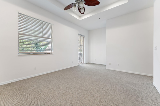 4329 Savannah Bay Pl, Jupiter, FL 33458 - carpeted spare room with a ceiling fan, baseboards, and a tray ceiling