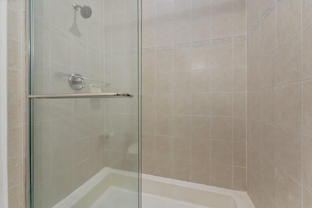 bathroom with a shower with shower door