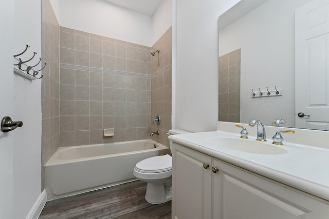 full bathroom with wood-type flooring, toilet, vanity, and tiled shower / bath