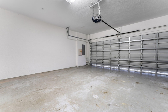 garage featuring a garage door opener and electric panel