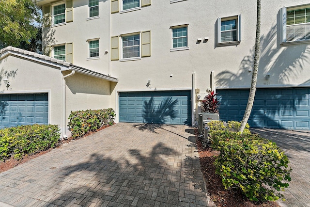 4329 Savannah Bay Pl, Jupiter, FL 33458 - townhome / multi-family property featuring a garage, stucco siding, and decorative driveway