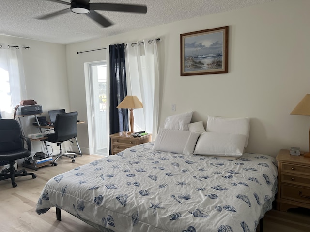 bedroom featuring ceiling fan, a textured ceiling, and light hardwood / wood-style flooring