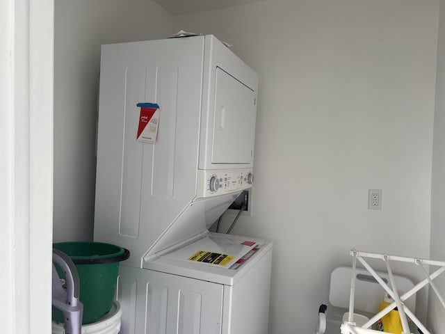 washroom with stacked washer / drying machine