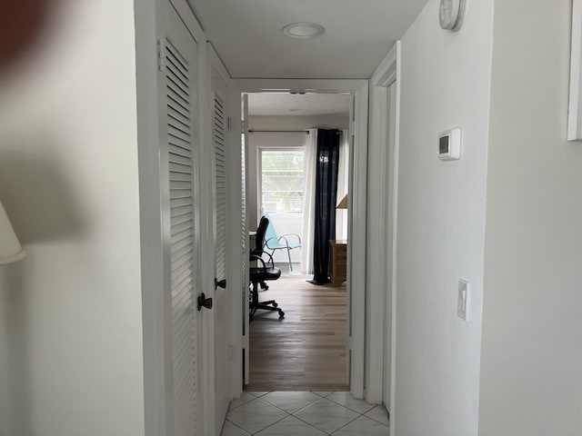 corridor with light tile patterned flooring