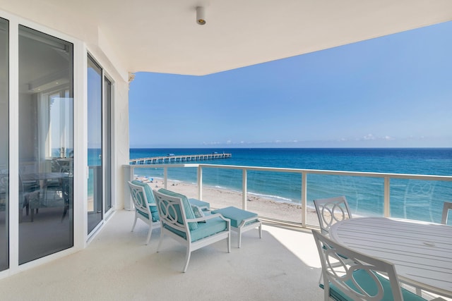 balcony with a view of the beach and a water view