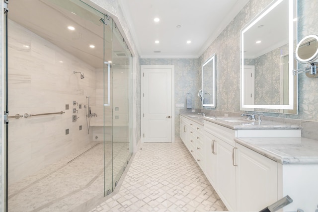 bathroom with vanity, a shower with shower door, and ornamental molding