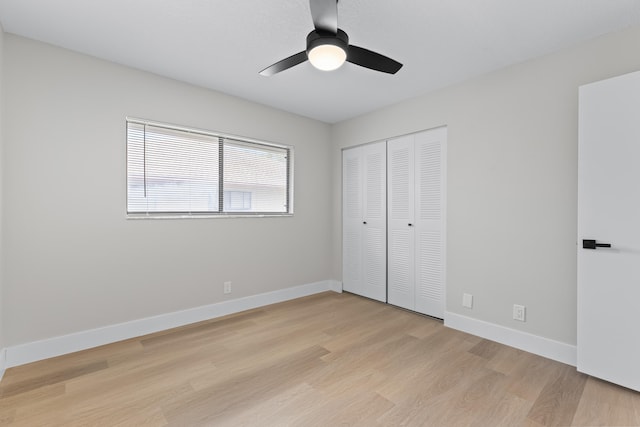 unfurnished bedroom featuring ceiling fan, light hardwood / wood-style floors, and a closet